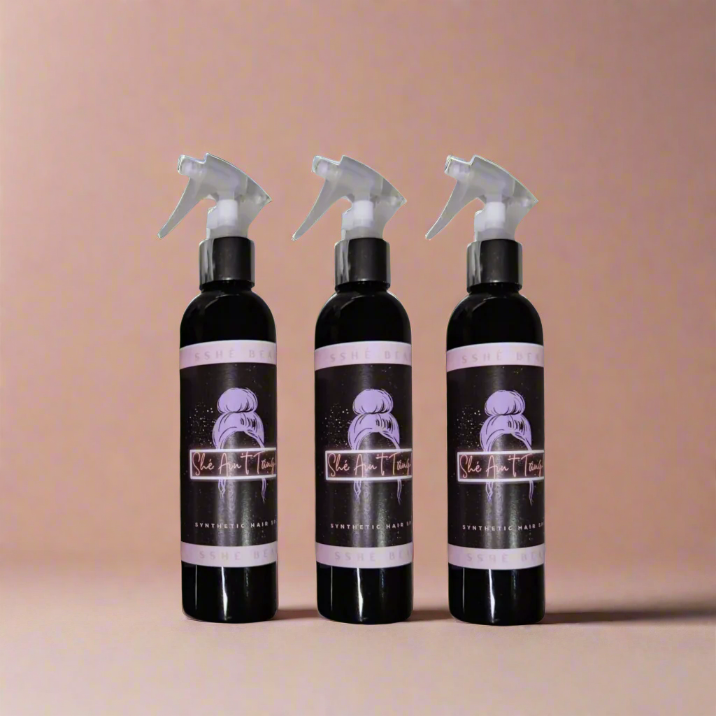 three product bottles of SShe Ain't Tangled, synthetic wig detangling sprays